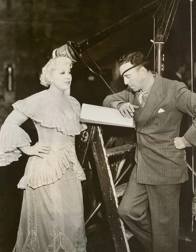 Actress Mae West with Director Raoul Walsh on Set